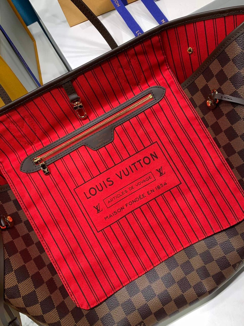 LV brown handbag with red inside